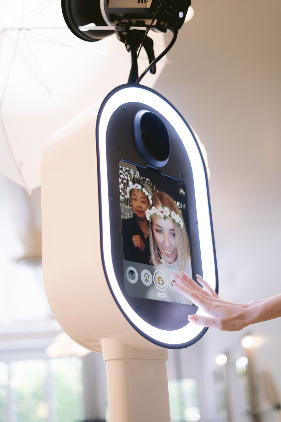 Guests using the Meridian Moments photo booth touchscreen with a filter
