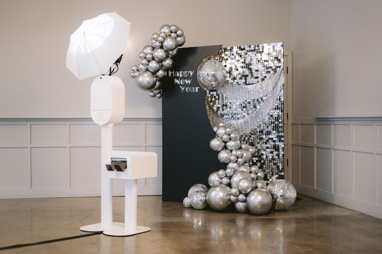 Photo booth set up with a premium Happy New Year disco backdrop