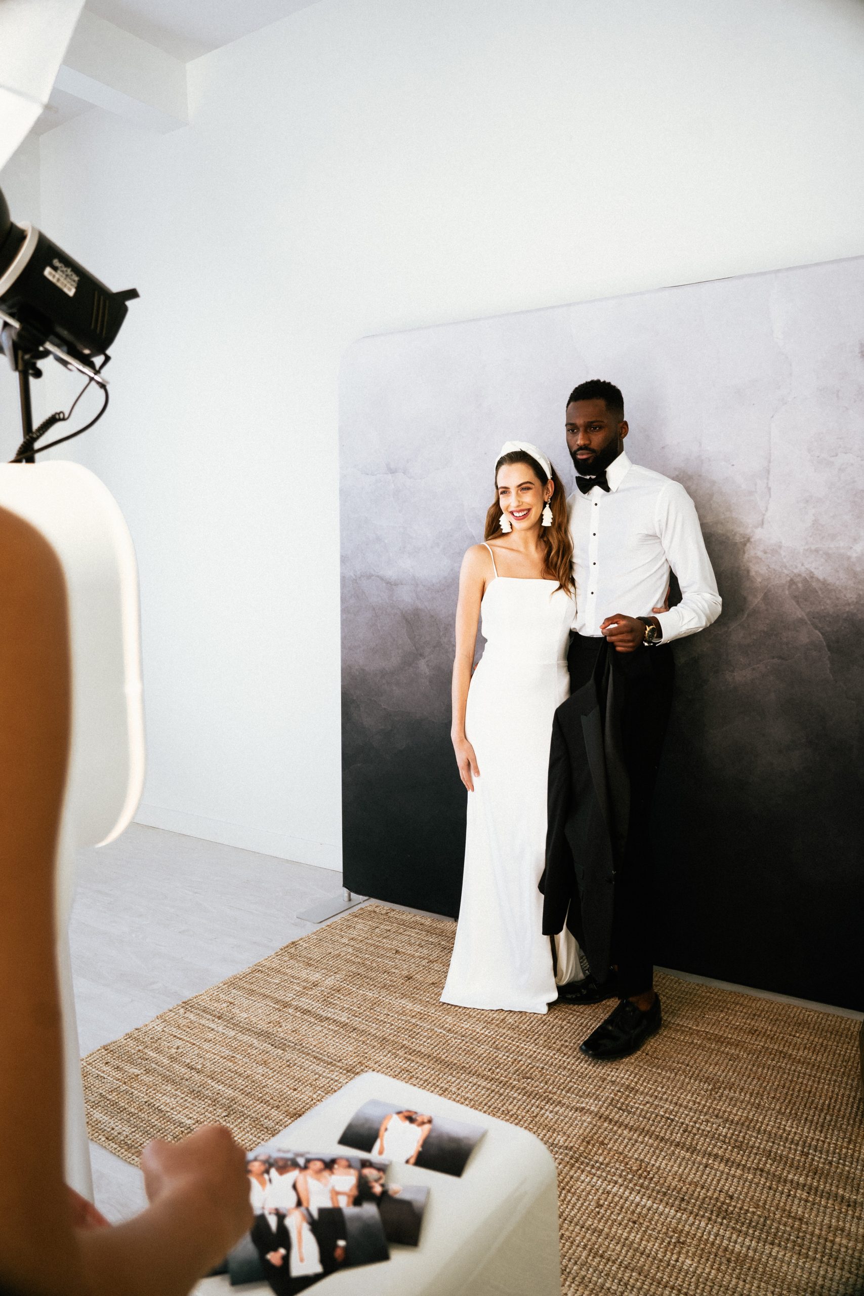 Bride and groom posing together at the Atlas backdrop