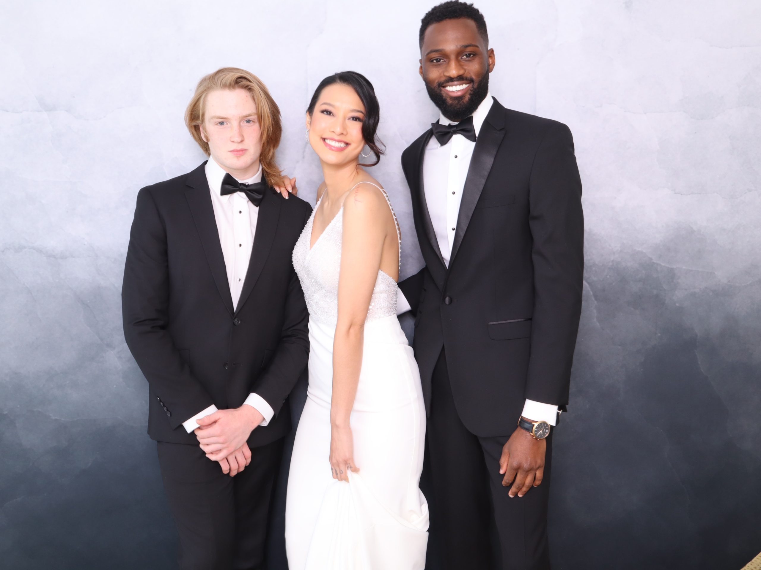 Wedding party members in formalwear at the photo booth